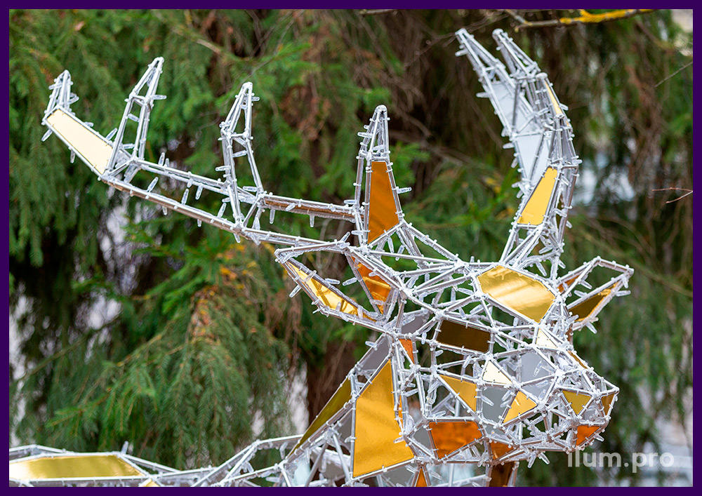 Полигональные фигуры в парке - олень из алюминия и золотого композита с гирляндами